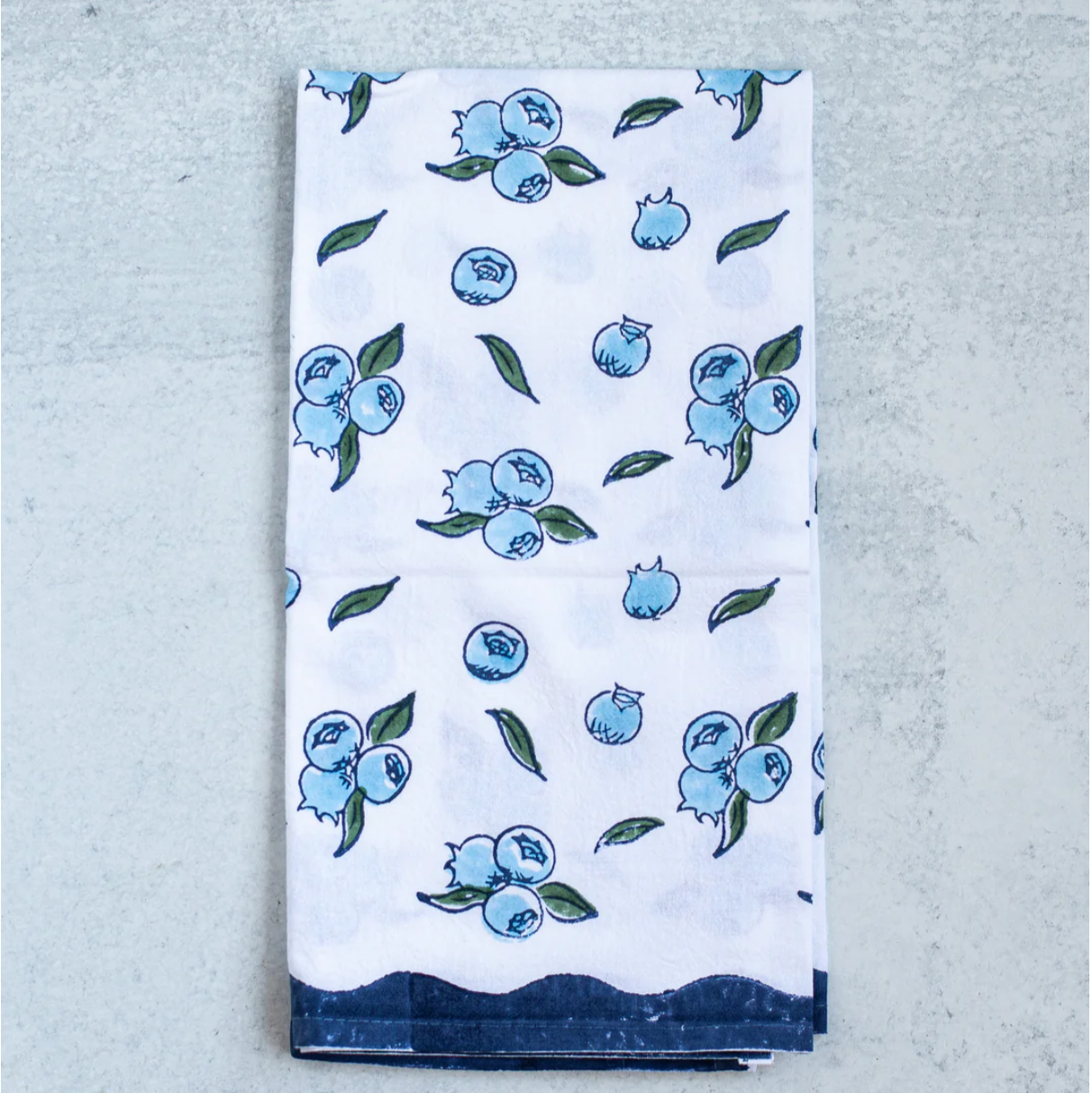 blueberry pattern cotton tea towel folded on a table