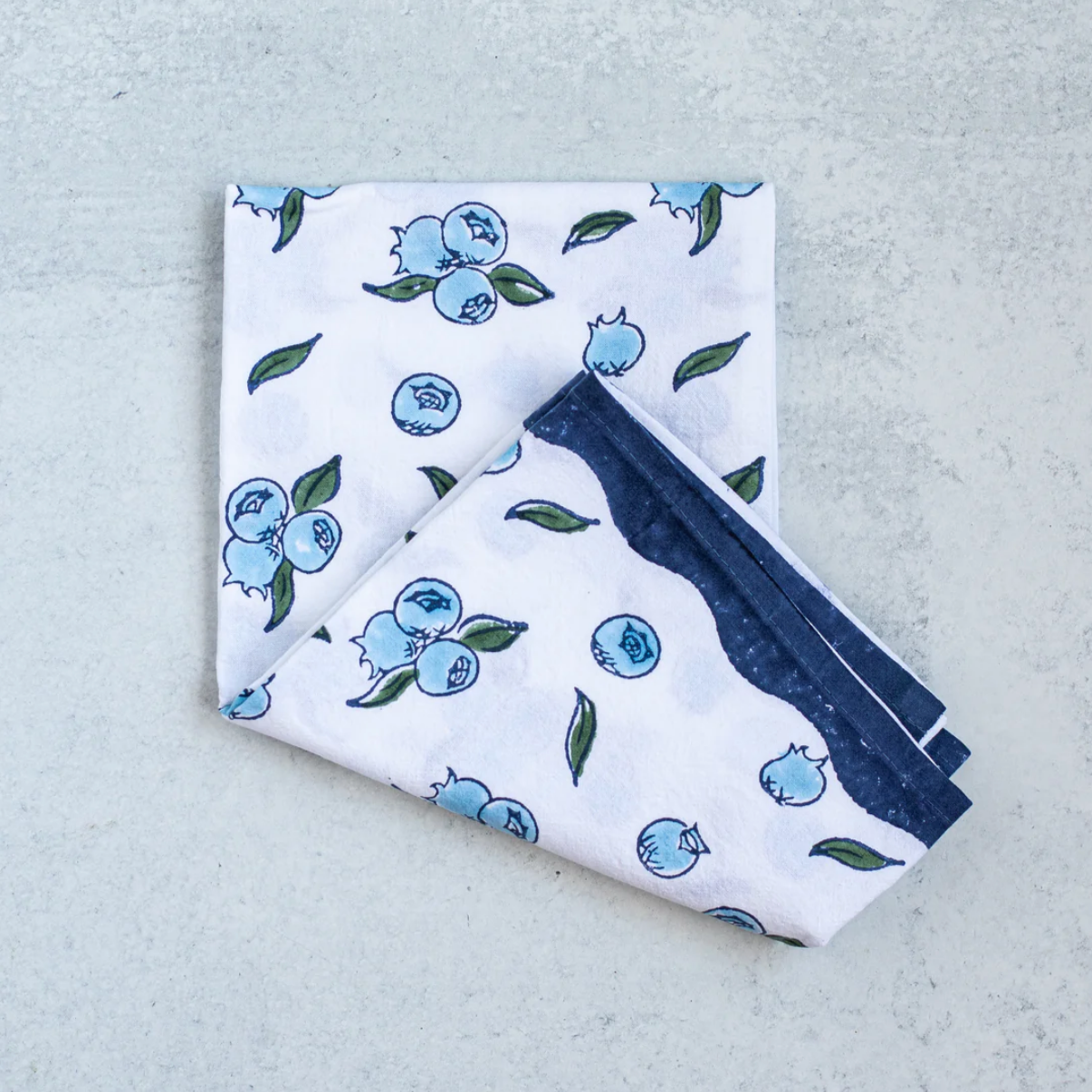 cotton blueberry tea towel folded in half on table