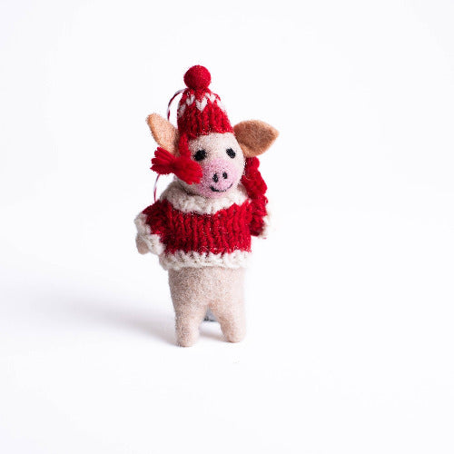 Small handmade felt santa pig ornament wearing a red sweater and hat on a white background