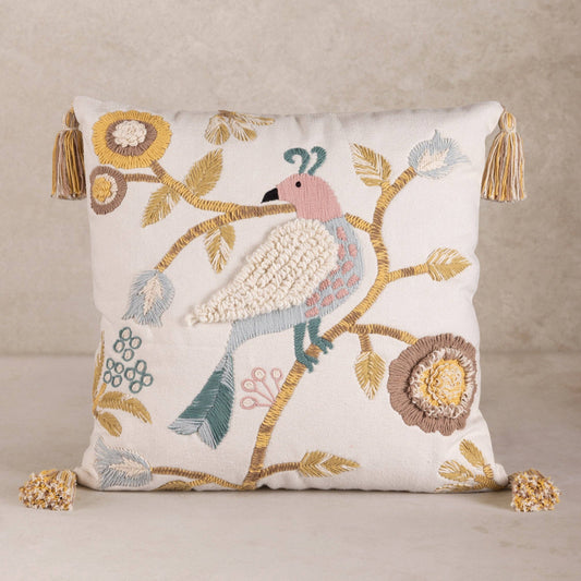 Handmade decorative pillow with embroidered bird and floral patterns on a beige background