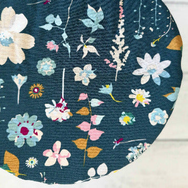 Floral-patterned bowl cover on a bowl with a white background
