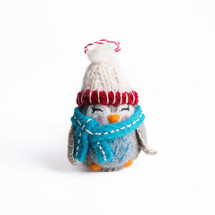 felt hand Knitted owl ornament wearing a red hat and blue scarf on a white background