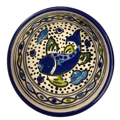 Ceramic plate with fish design on a white background